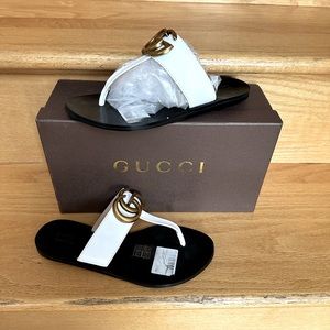 White leather thongs with gold detail . EUR 36